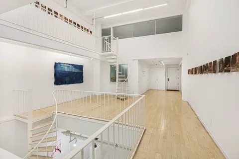 a view of a balcony with wooden floor and staircase