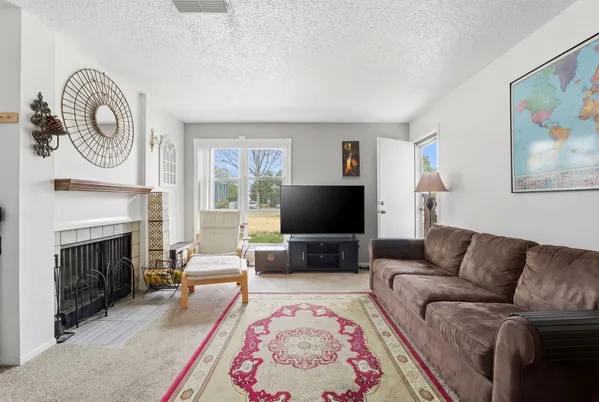 a living room with furniture and next to a window