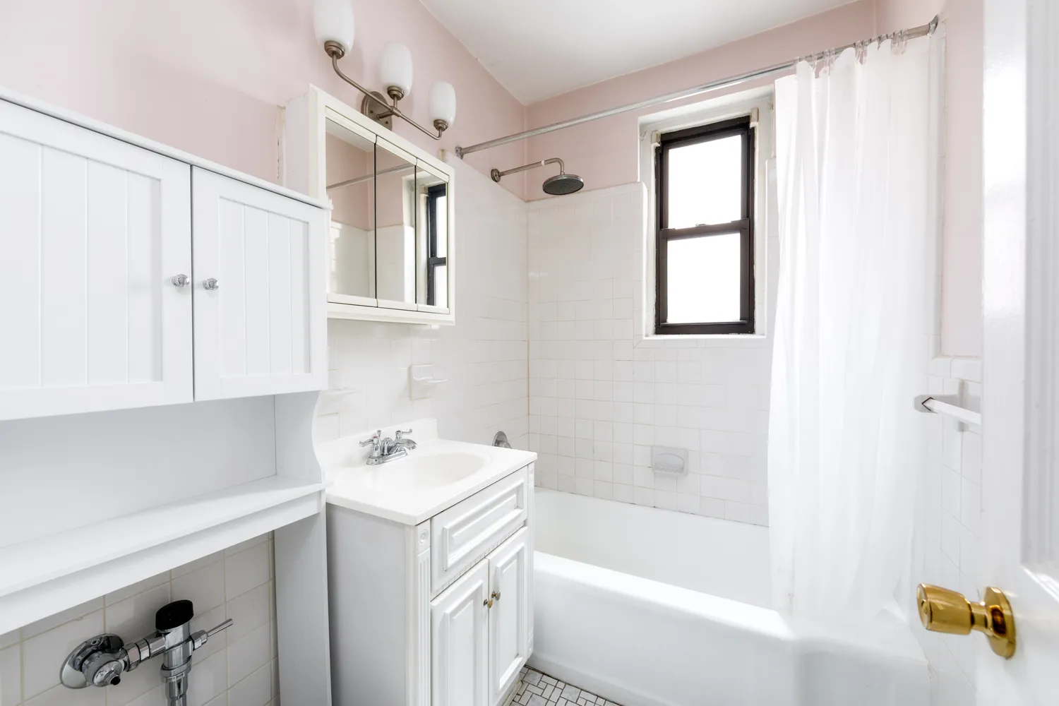 a bathroom with a bathtub a sink and a window