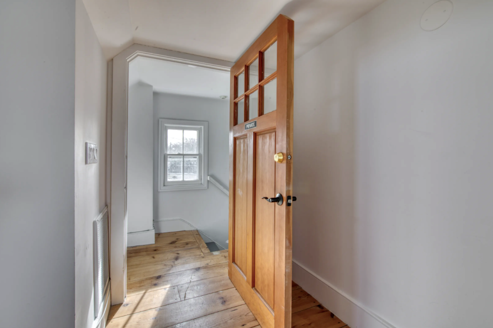 23 Bridge Street Sag Harbor, NY 11963 - Photo 13 of 23 a view of a hallway with a livingroom and a bathroom with sink