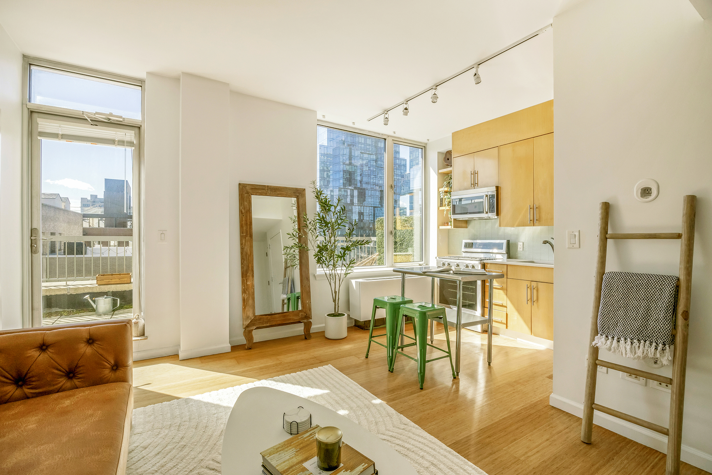 26 Broadway, Unit 704 Brooklyn, NY 11249 - Photo 2 of 20 a living room with furniture and a table