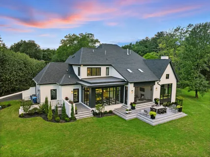 a front view of a house with yard and green space