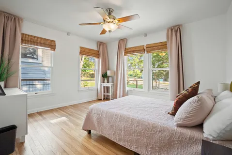 a bedroom with a bed and a large window