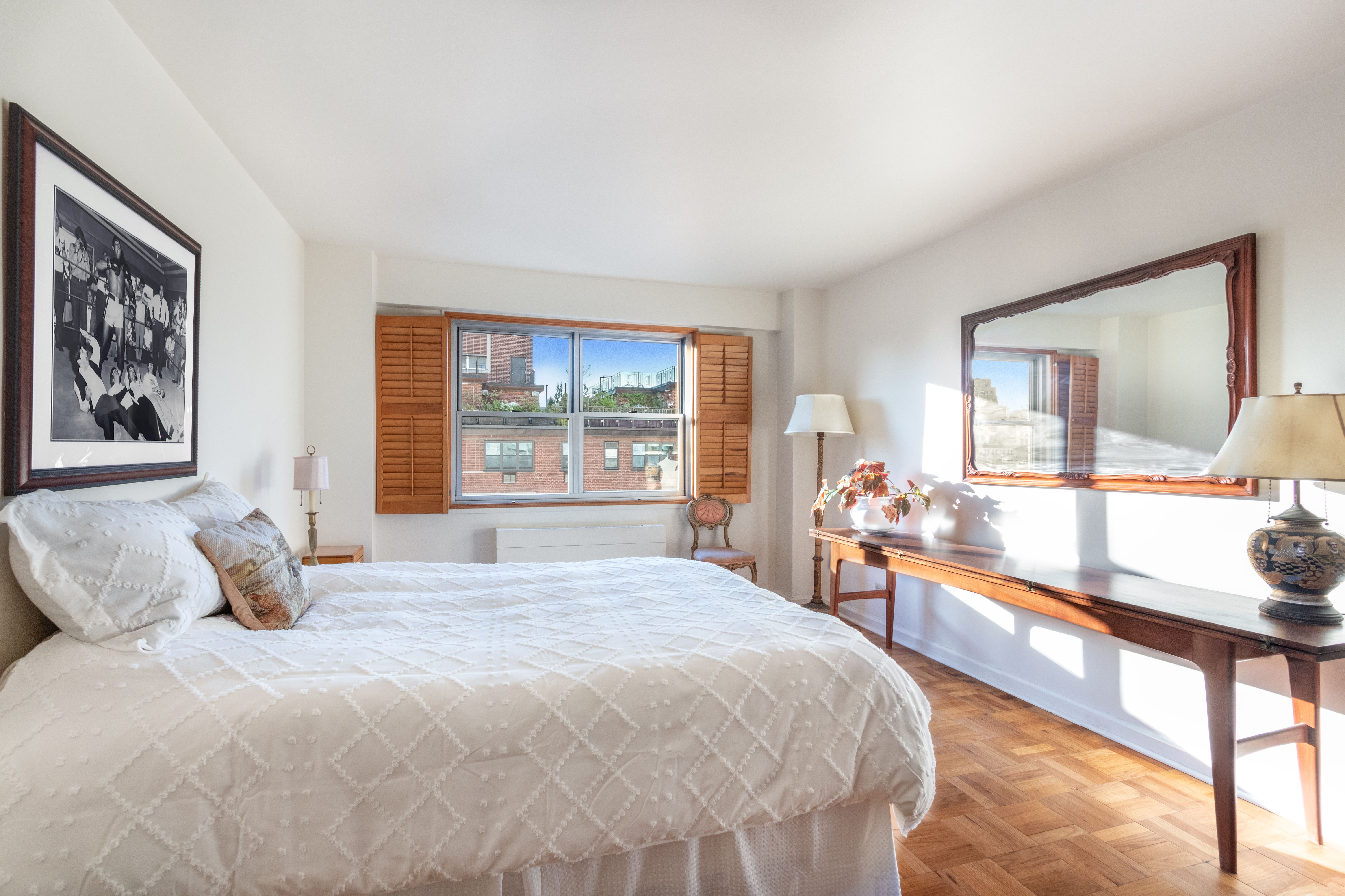 70 East 10th Street, Unit 14M Manhattan, NY 10003 - Photo 10 of 22 a bedroom with a large bed and a large window