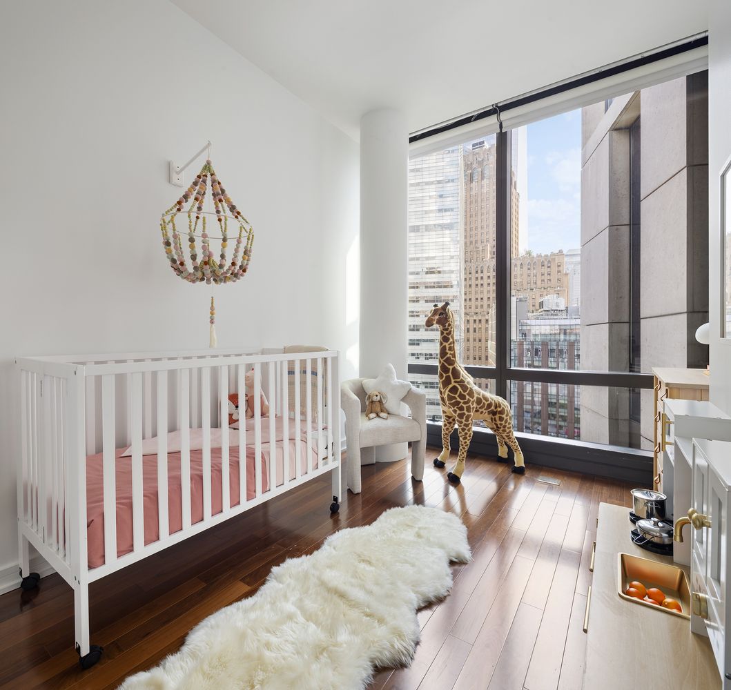 a bedroom with furniture and a large window