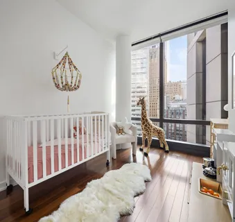 a bedroom with furniture and a large window
