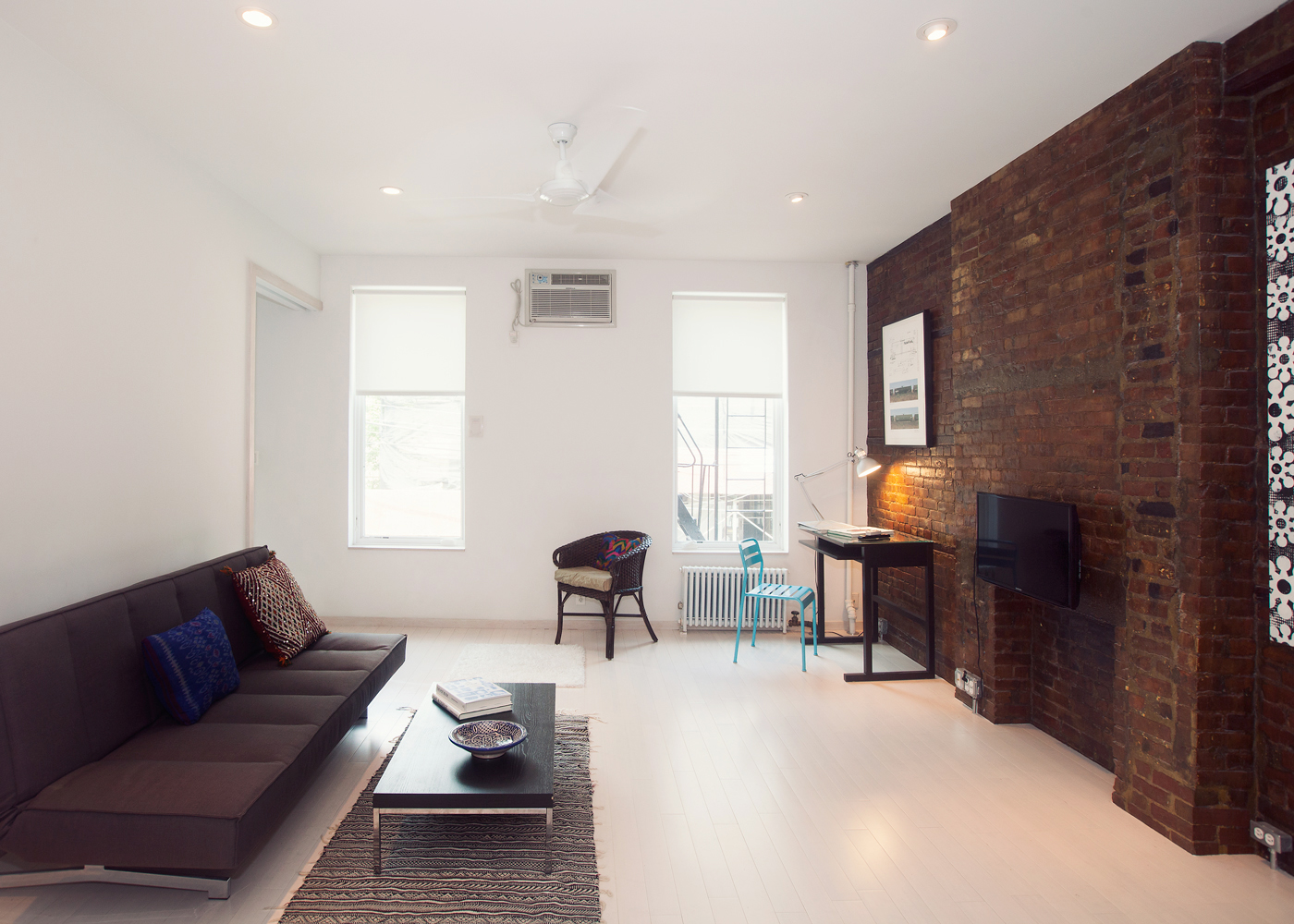 5-46 50th Avenue Queens, NY 11101 - Photo 8 of 17 a living room with furniture and a window