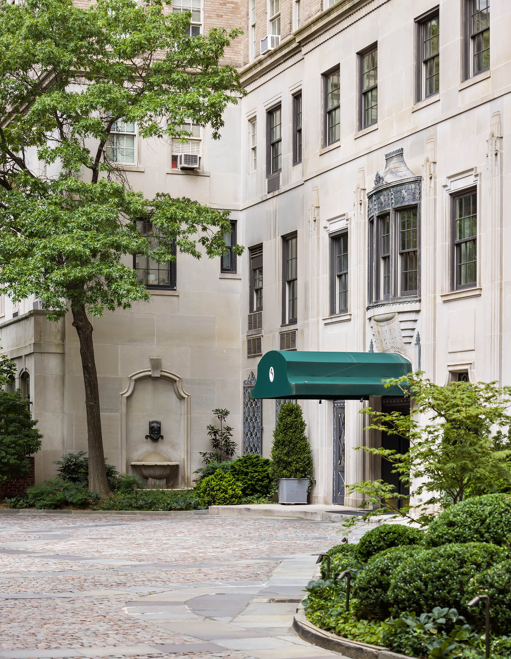 435 East 52nd Street, Unit 11A Manhattan, NY 10022 - Photo 20 of 21 a front view of a house with a garden and plants
