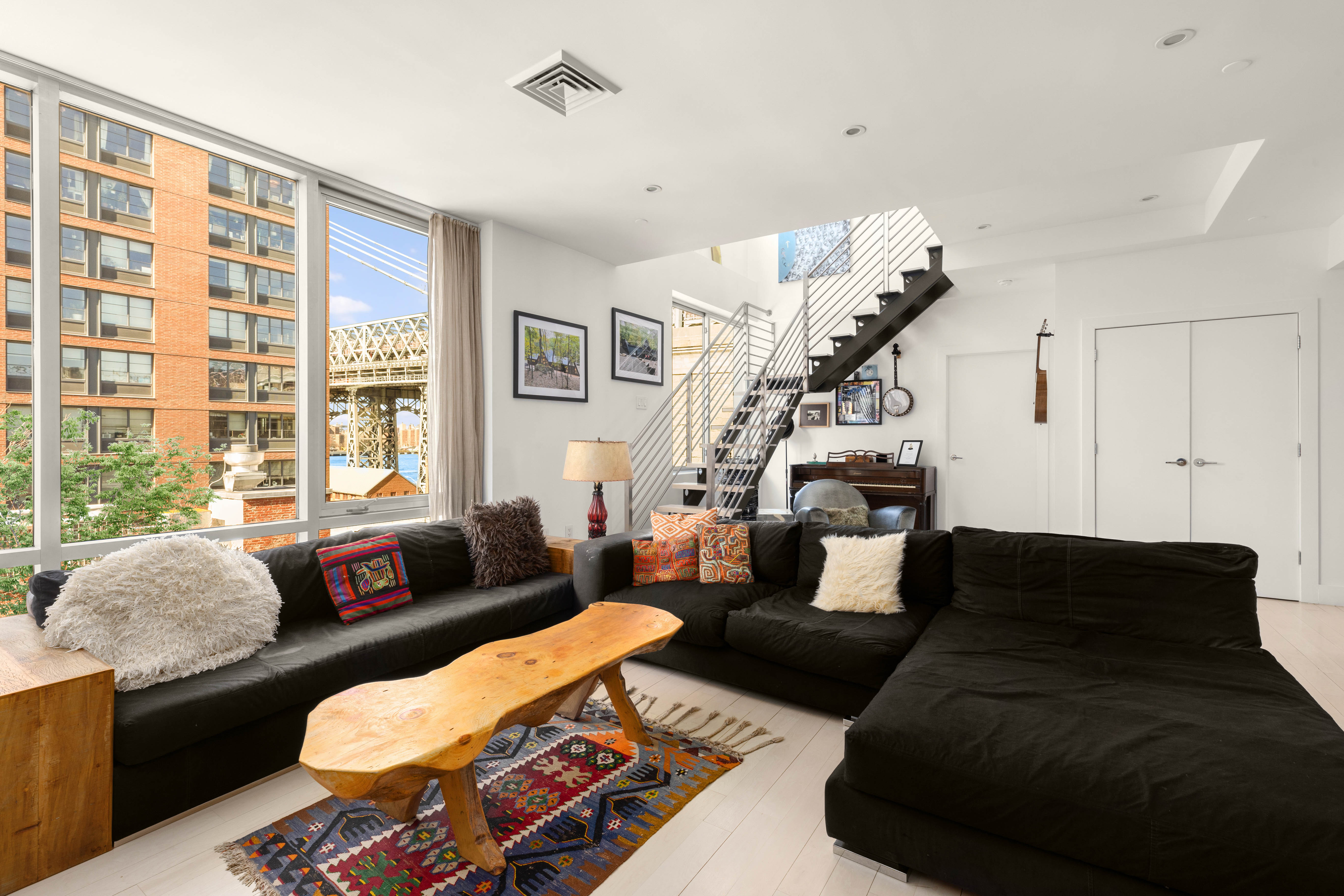 24 Dunham Place, Unit PHA Brooklyn, NY 11249 - Photo 5 of 19 a living room with furniture and a large window