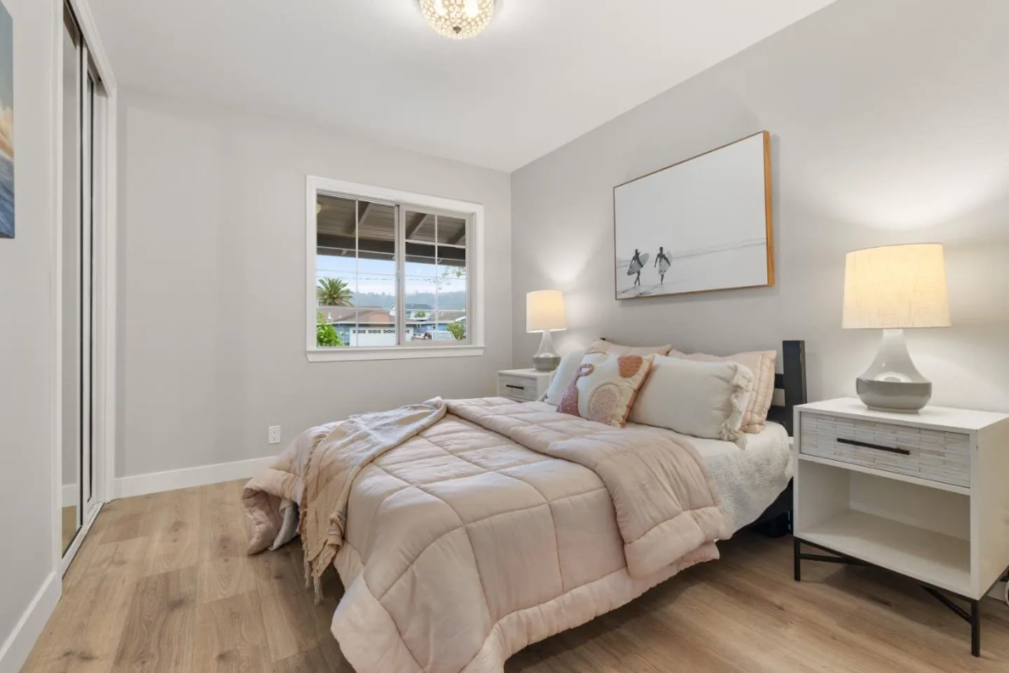 a bedroom with a bed and a mirror on dresser