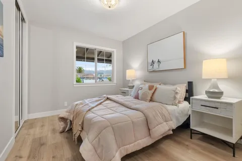 a bedroom with a bed and a mirror on dresser