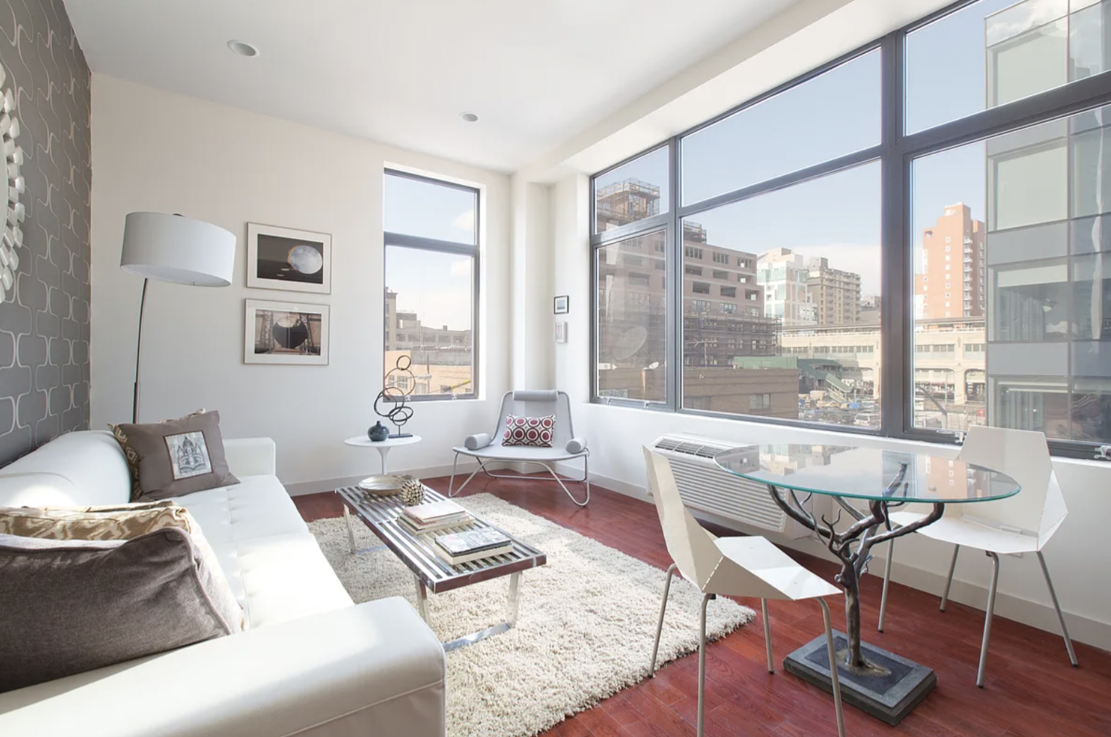 42-37 27th Street, Unit 8B Queens, NY 11101 - Photo 2 of 11 a living room with furniture and a large window