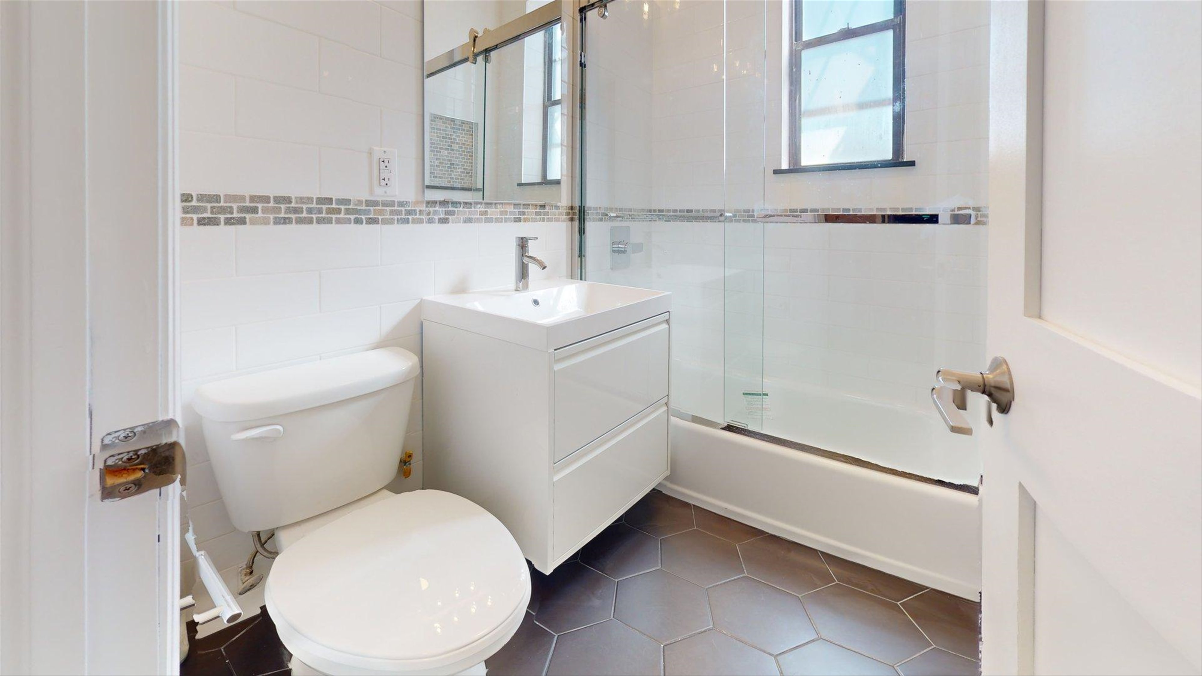 7609 4th Avenue, Unit E14 Brooklyn, NY 11209 - Photo 13 of 15 a white toilet sitting next to a bathroom sink