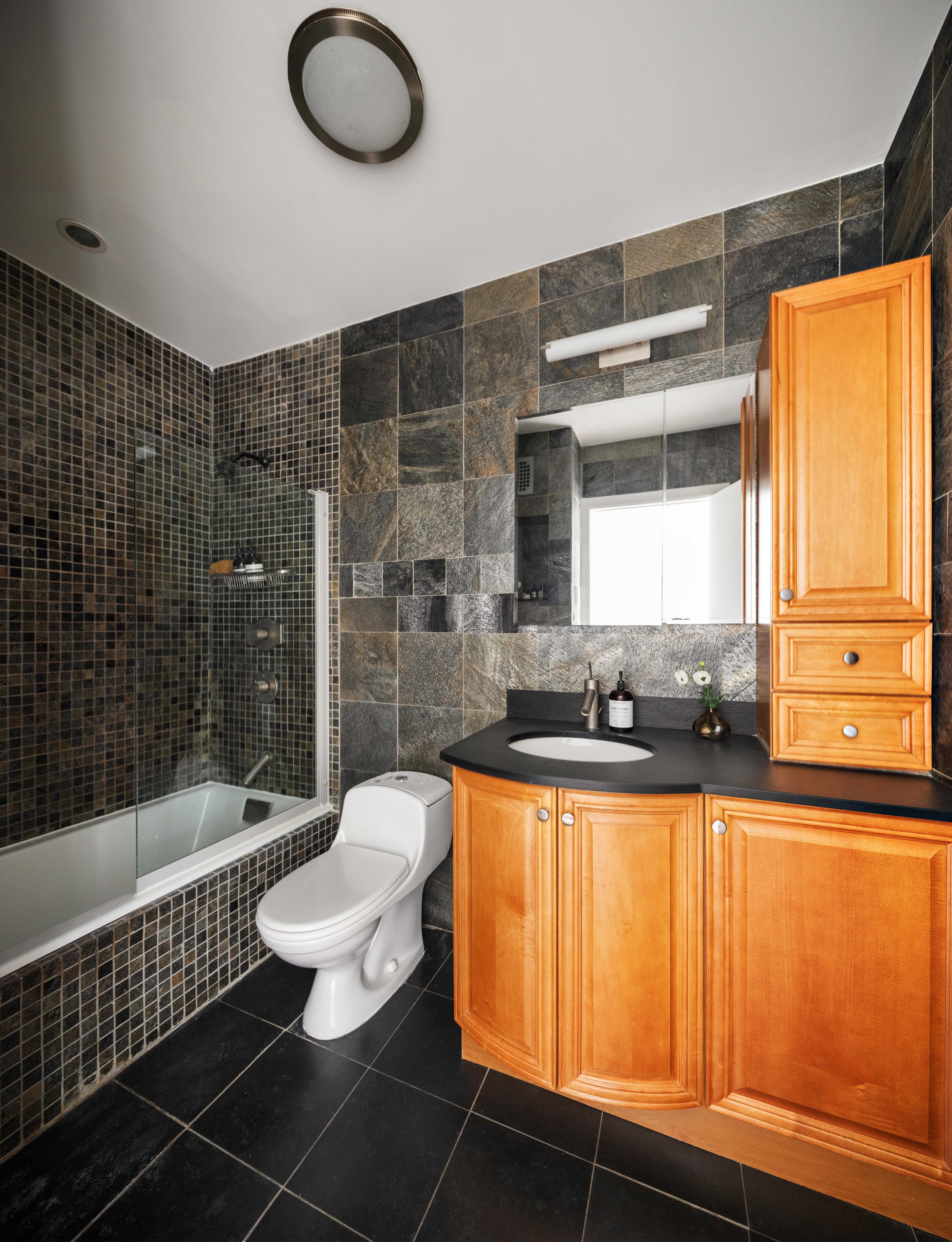 204 West Houston Street, Unit 4B Manhattan, NY 10014 - Photo 7 of 10 a bathroom with a sink a bathtub and a shower