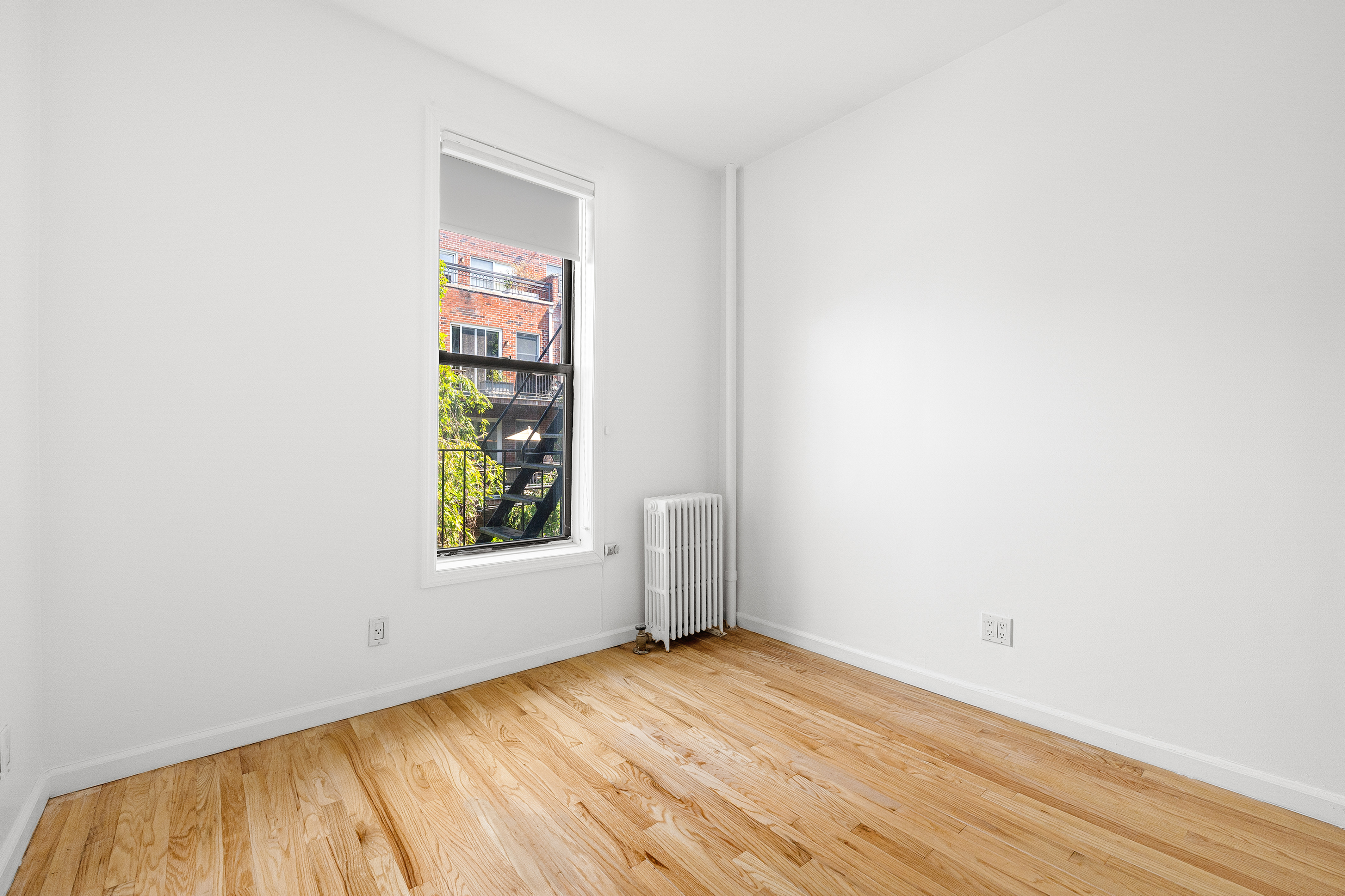 325 3rd Street, Unit 2A Brooklyn, NY 11215 - Photo 4 of 13 an empty room with wooden floor and windows