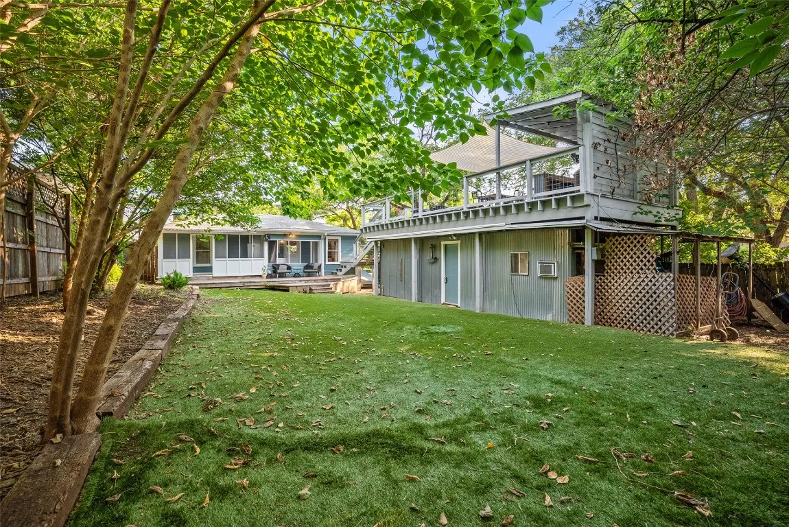 a view of a house with a yard and sitting area