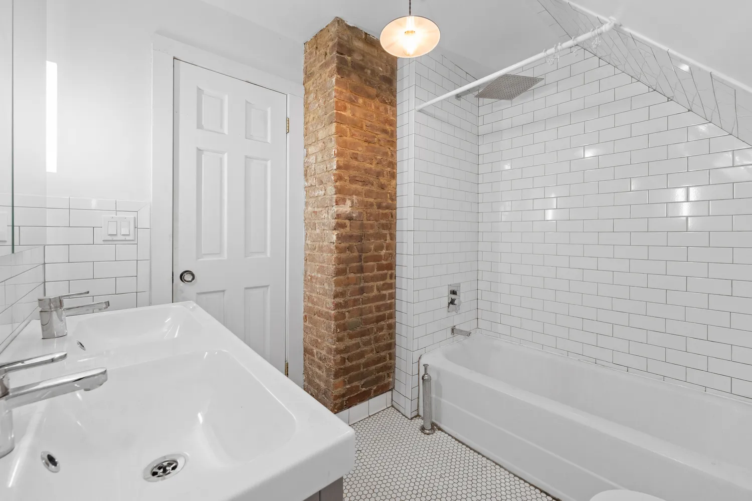 a bathroom with a tub a sink and a shower