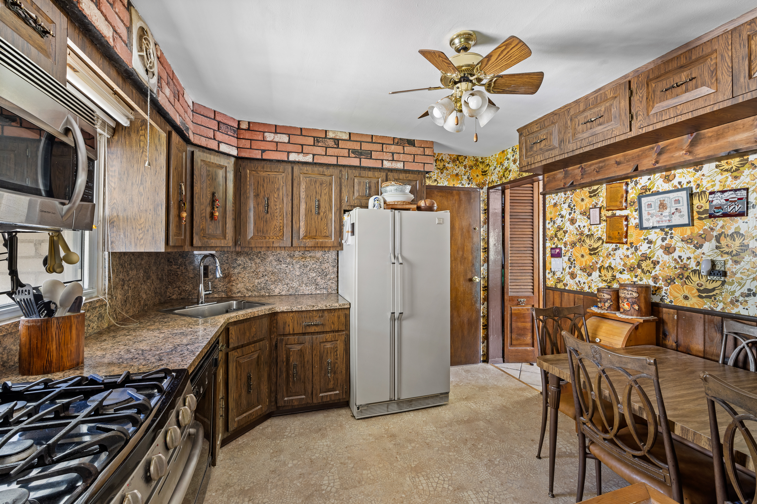 14-28 140th Street Queens, NY 11357 - Photo 6 of 14 a kitchen with stainless steel appliances granite countertop a stove and a refrigerator