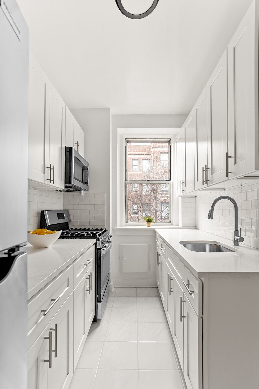 37-16 80th Street, Unit 32 Queens, NY 11372 - Photo 4 of 13 a kitchen with granite countertop a sink stove and cabinets