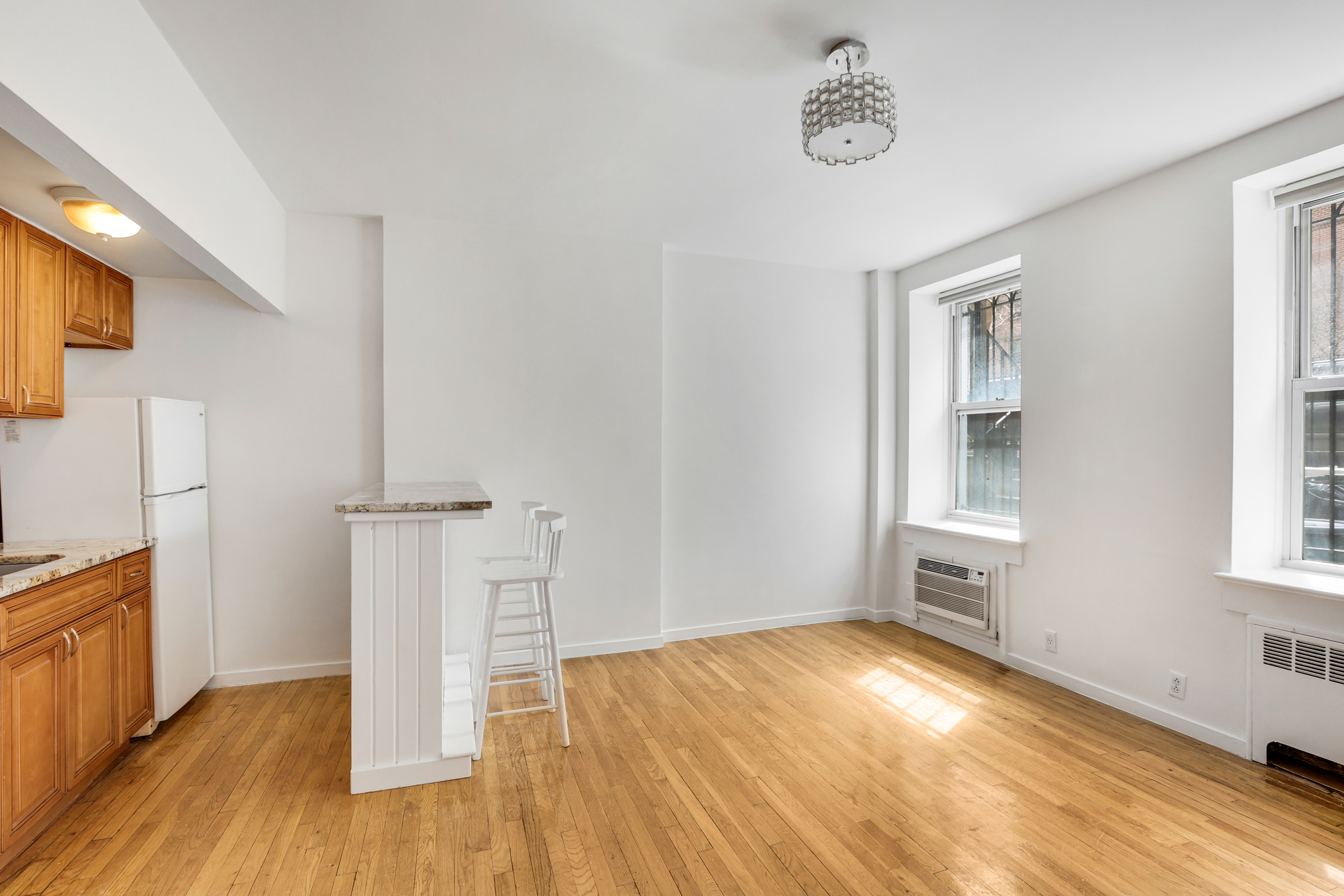141 West 94th Street, Unit 1F Manhattan, NY 10025 - Photo 8 of 9 a view of empty room with wooden floor and fan