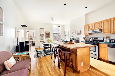 a kitchen with stainless steel appliances granite countertop a table and chairs