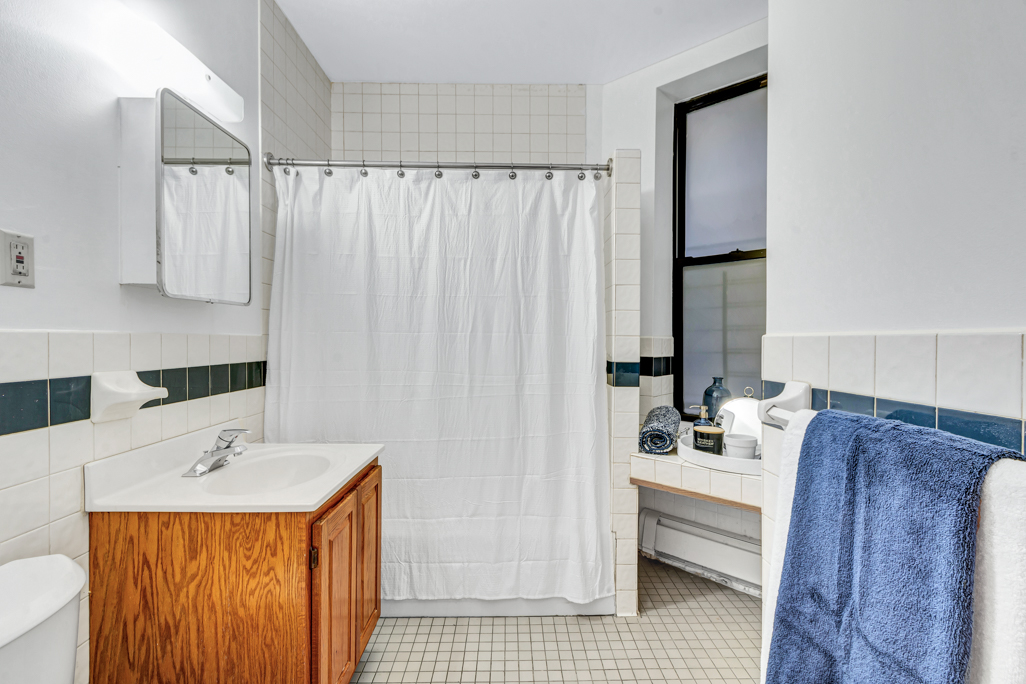 2322 Adam Clayton Powell Jr Boulevard, Unit 2G Manhattan, NY 10030 - Photo 7 of 8 a bathroom with a sink and a mirror