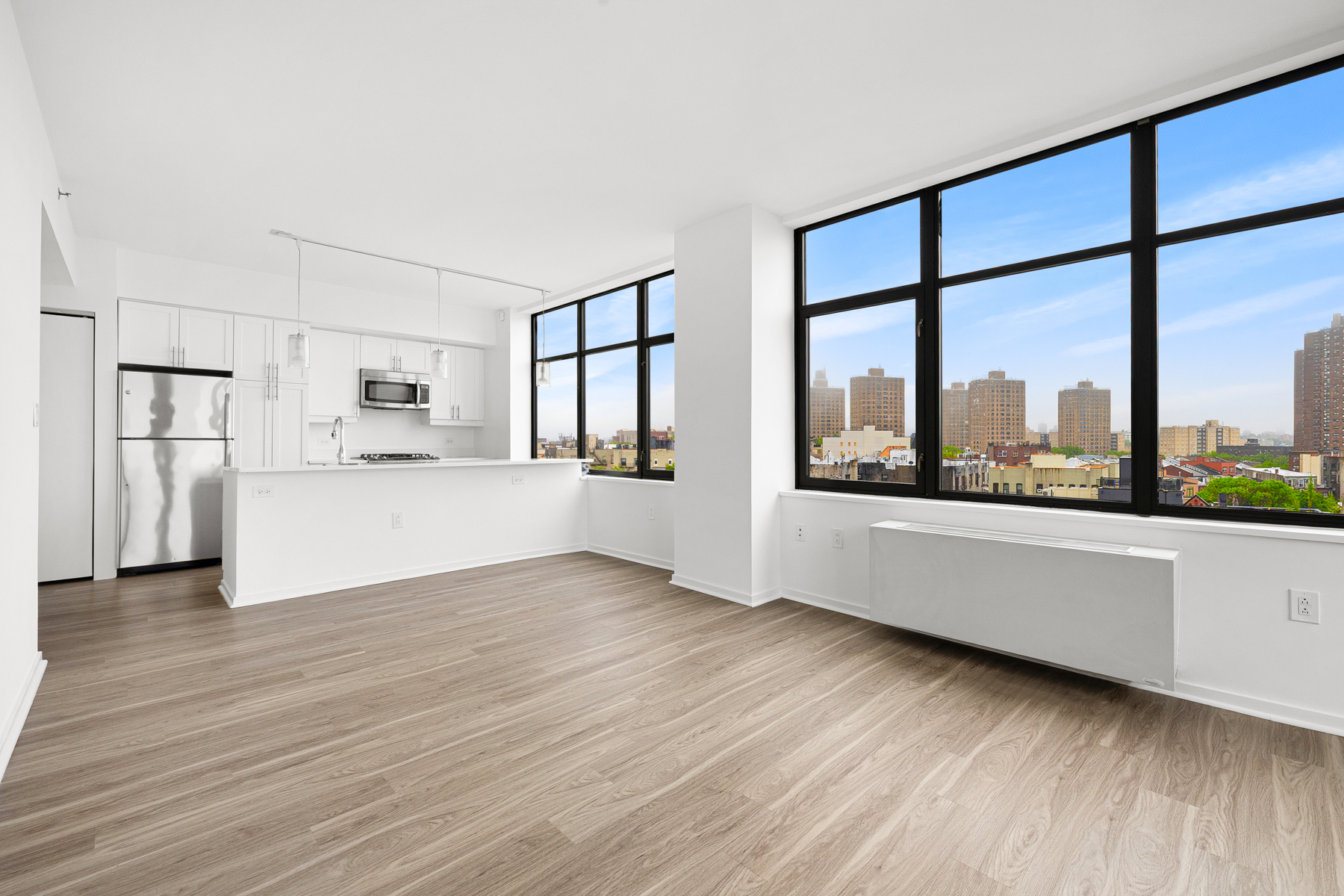 424 Bedford Avenue, Unit 6B Brooklyn, NY 11249 - Photo 1 of 11 a view of an empty room with a window and wooden floor