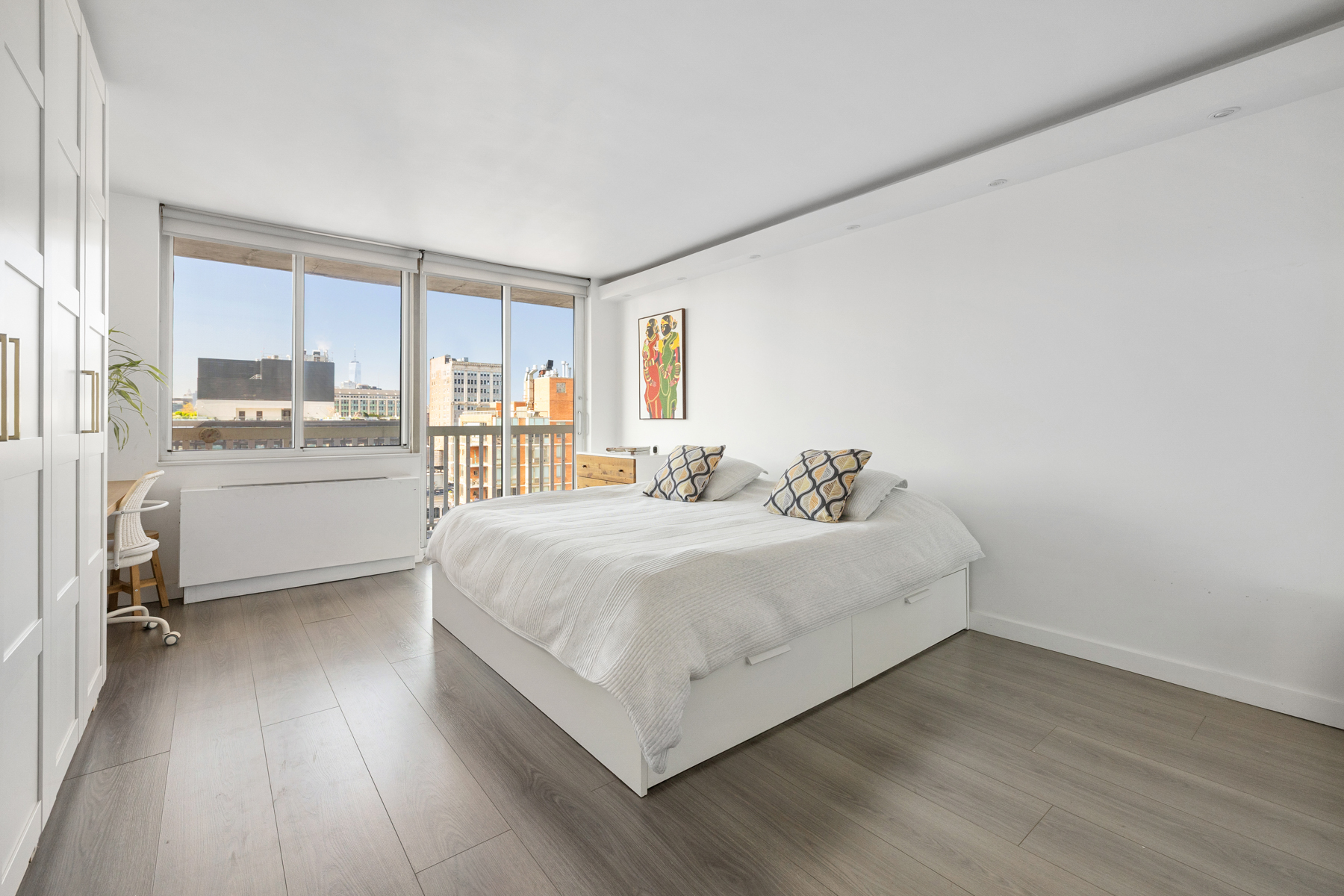 50 Lexington Avenue, Unit 25E Manhattan, NY 10010 - Photo 9 of 13 a bedroom with a bed and a large window