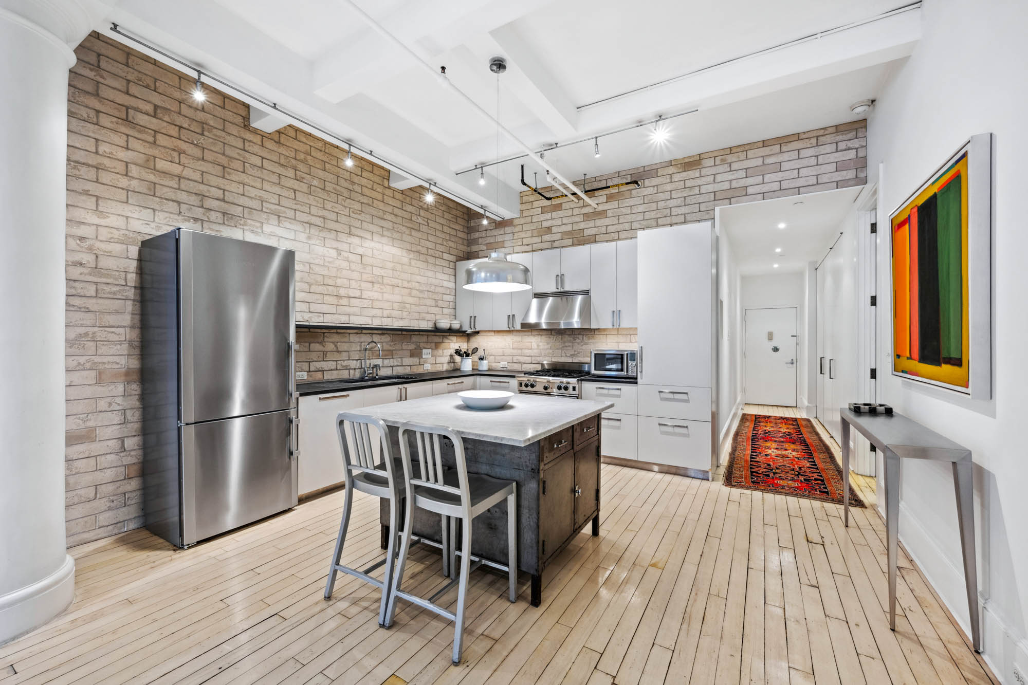 7 East 20th Street, Unit 6R Manhattan, NY 10003 - Photo 4 of 14 a kitchen with a sink appliances and cabinets