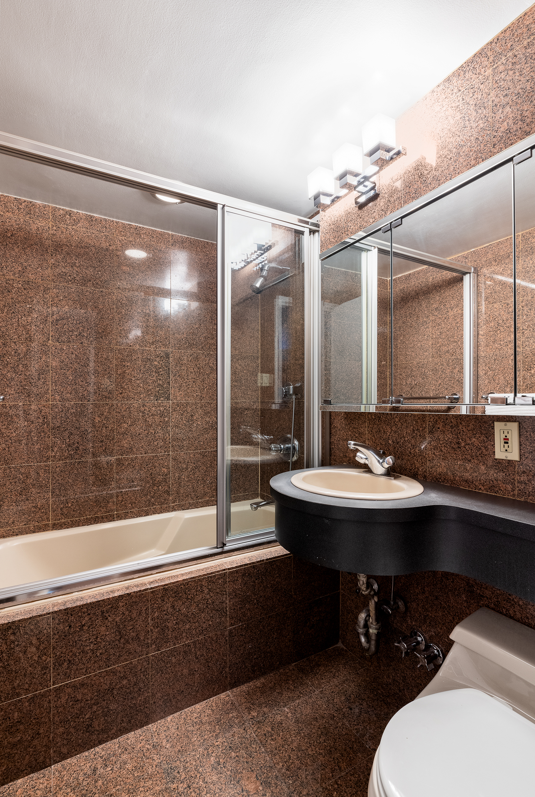 1036 Park Avenue, Unit 2D Manhattan, NY 10028 - Photo 12 of 14 a bathroom with a sink and a mirror