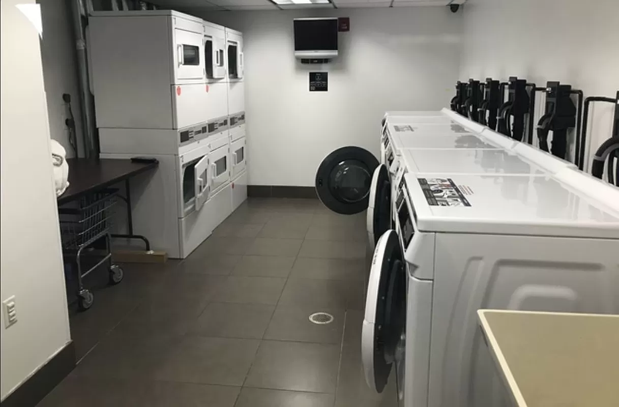 100 West 39th Street, Unit 37E Manhattan, NY 10018 - Photo 9 of 11 a utility room with dryer and washer