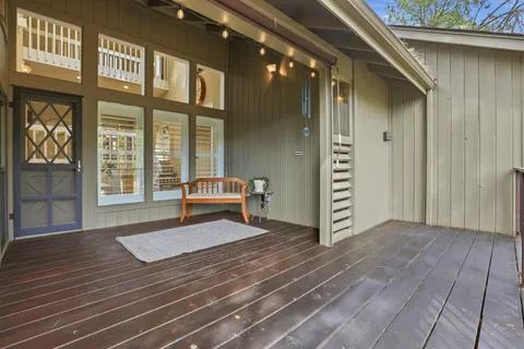 a view of a dining room with furniture wooden floor and a chandelier