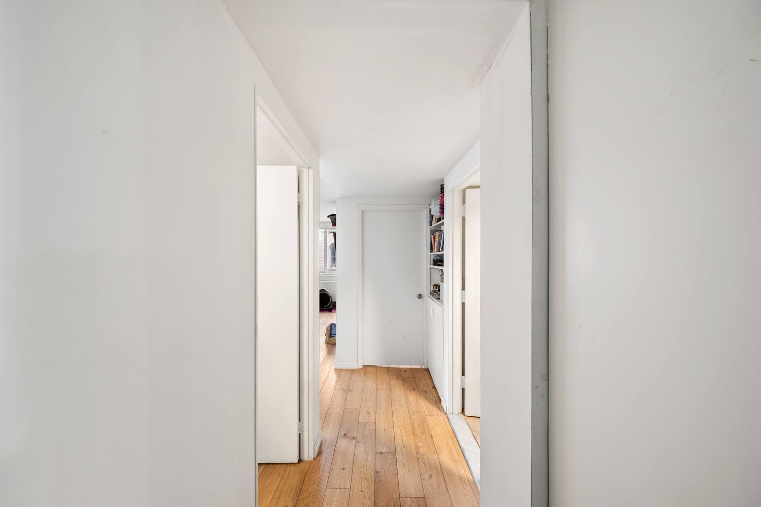 a view of a hallway with wooden floor