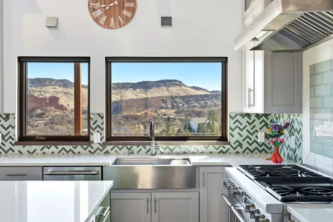 a bathroom with a sink vanity granite toilet and a glass door shower