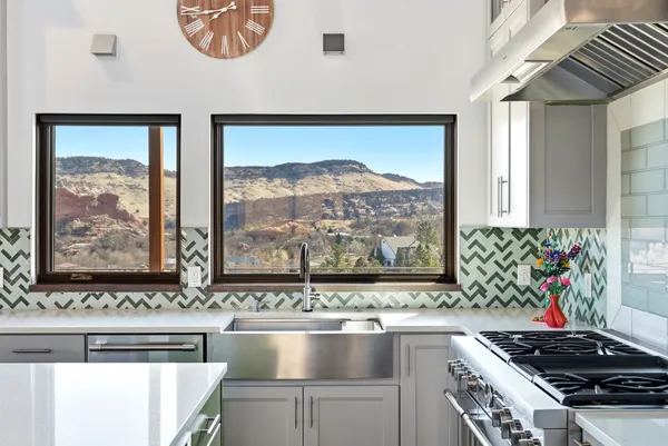 a bathroom with a sink vanity granite toilet and a glass door shower