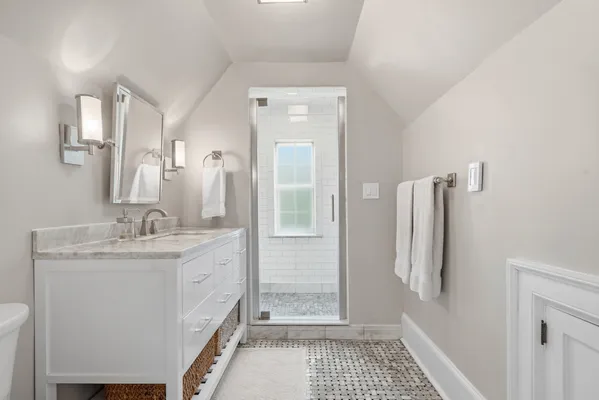a bathroom with a sink a toilet and a shower