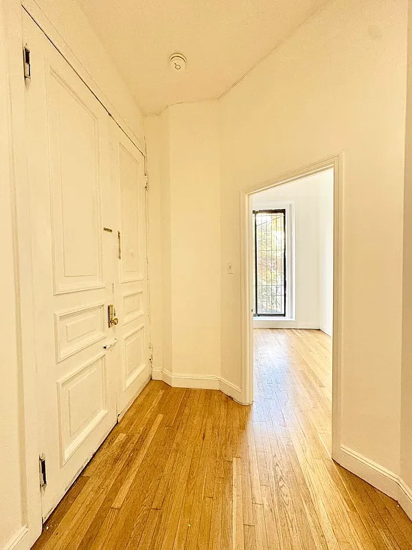 238 Gates Avenue, Unit 2 Brooklyn, NY 11238 - Photo 4 of 13 a view of a room with wooden floor and white walls