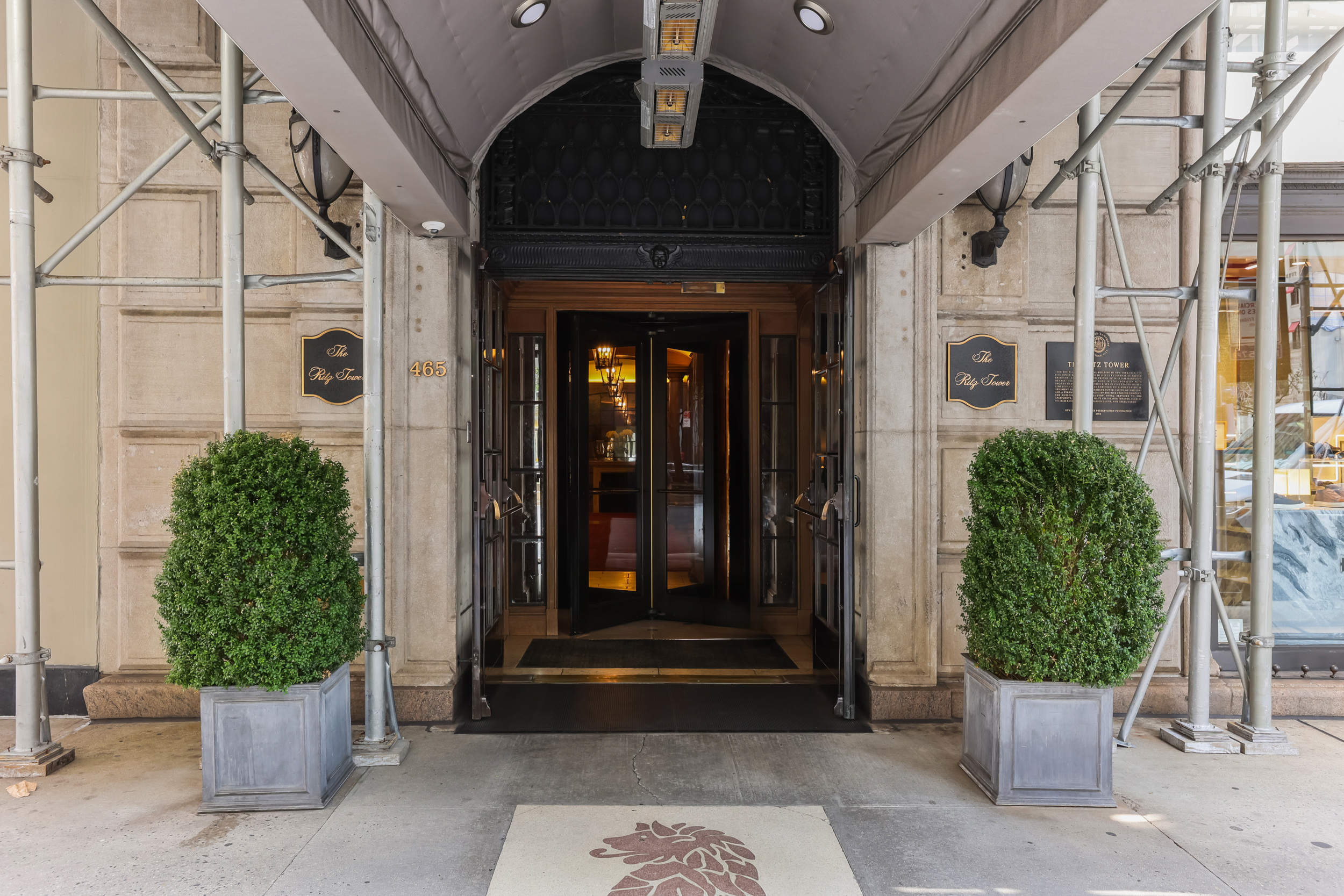465 Park Avenue, Unit 409 Manhattan, NY 10022 - Photo 10 of 11 a front view of a house with a garden