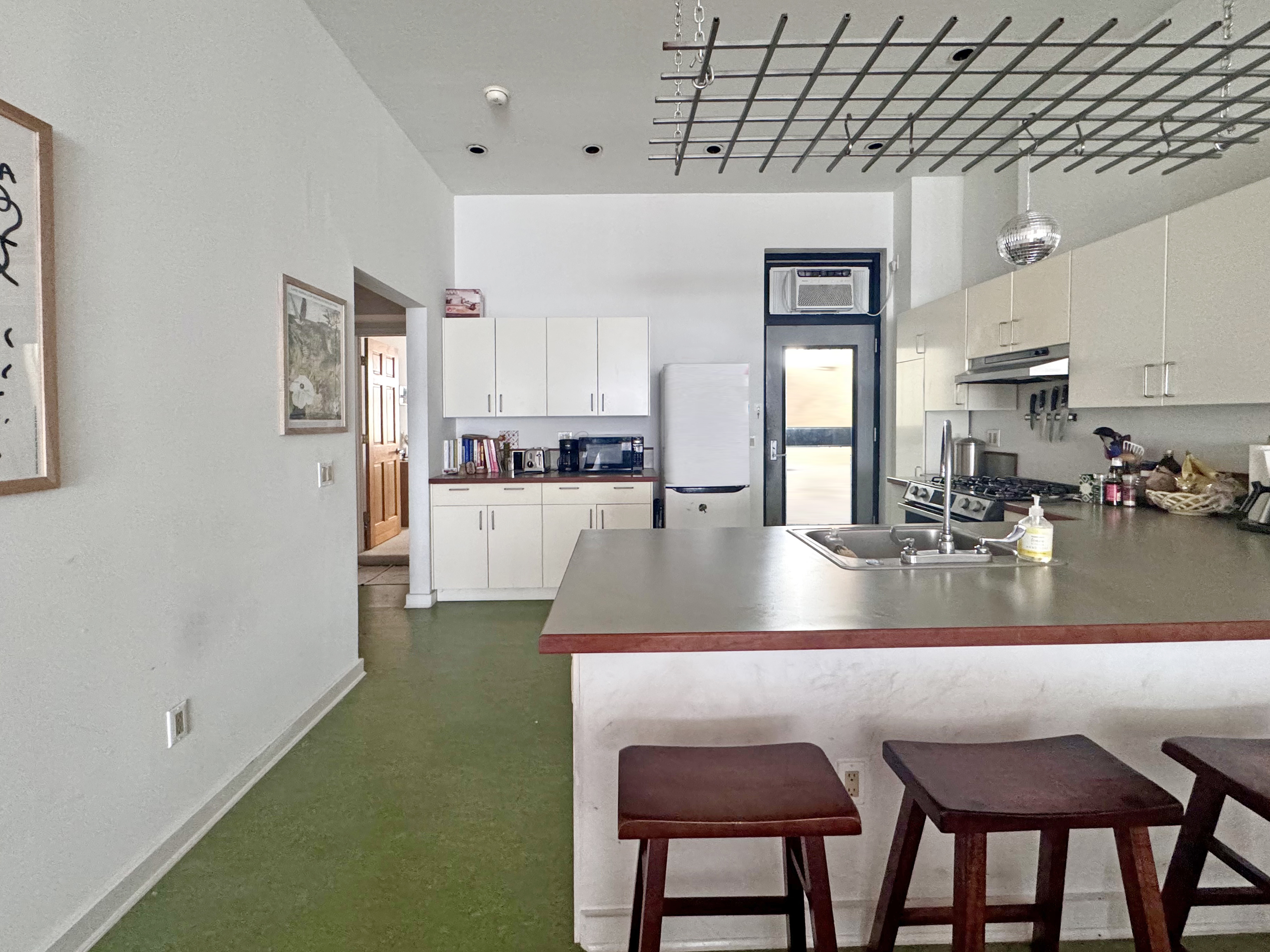 658 Classon Avenue Brooklyn, NY 11238 - Photo 7 of 15 a view of a kitchen with kitchen island a table and chairs in it