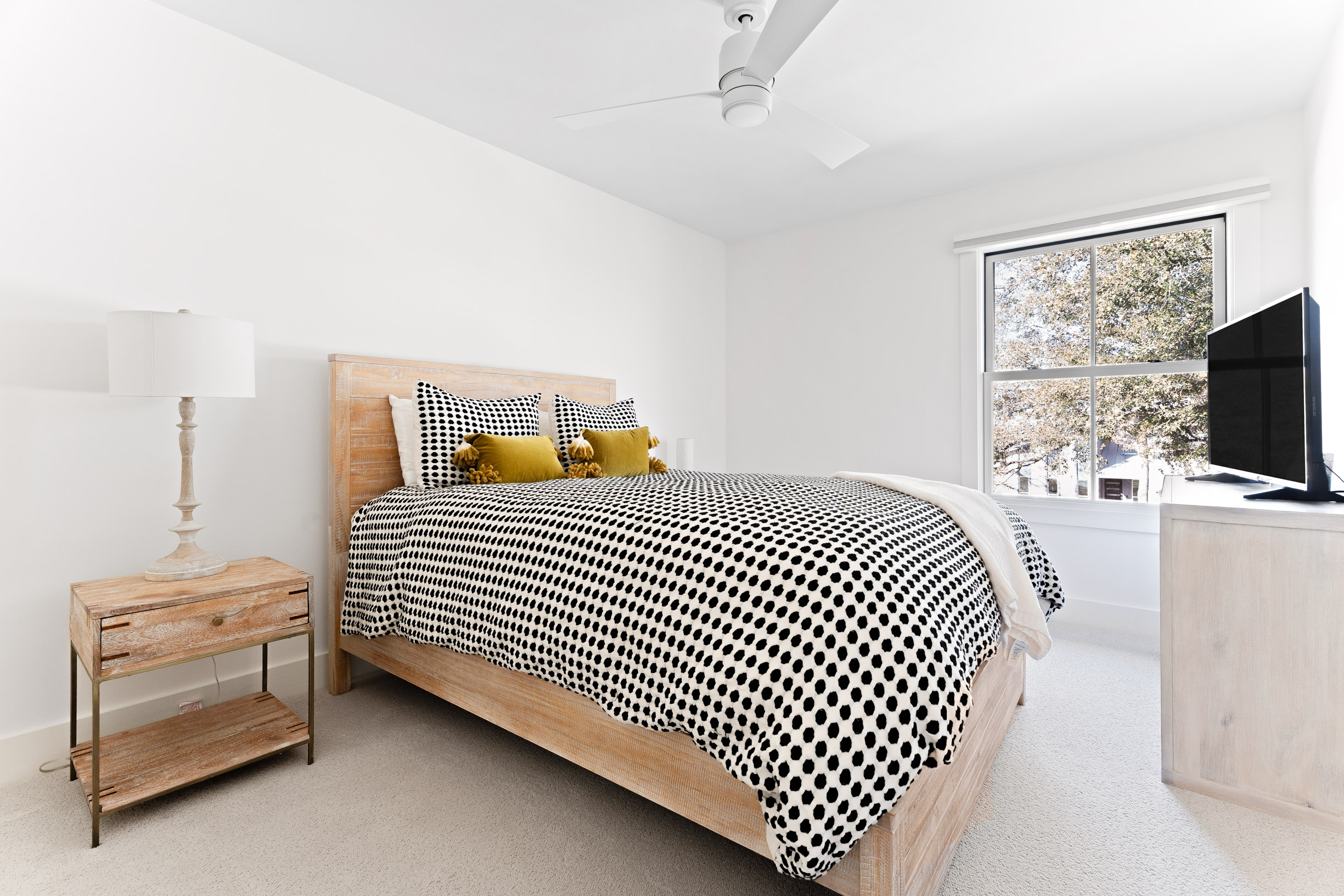 1317 Thaddeus Cove Austin, TX 78746 - Photo 14 of 22 a bedroom with a bed and a tv on the dresser