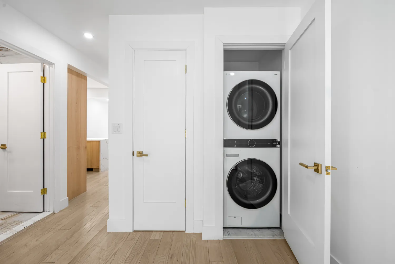a view of a hallway with washer and dryer