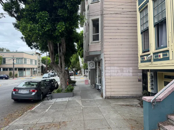 a couple of cars parked in front of a house