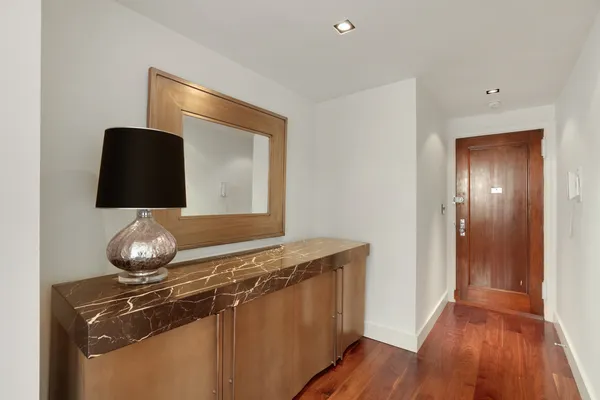 a living room with a sink and a mirror