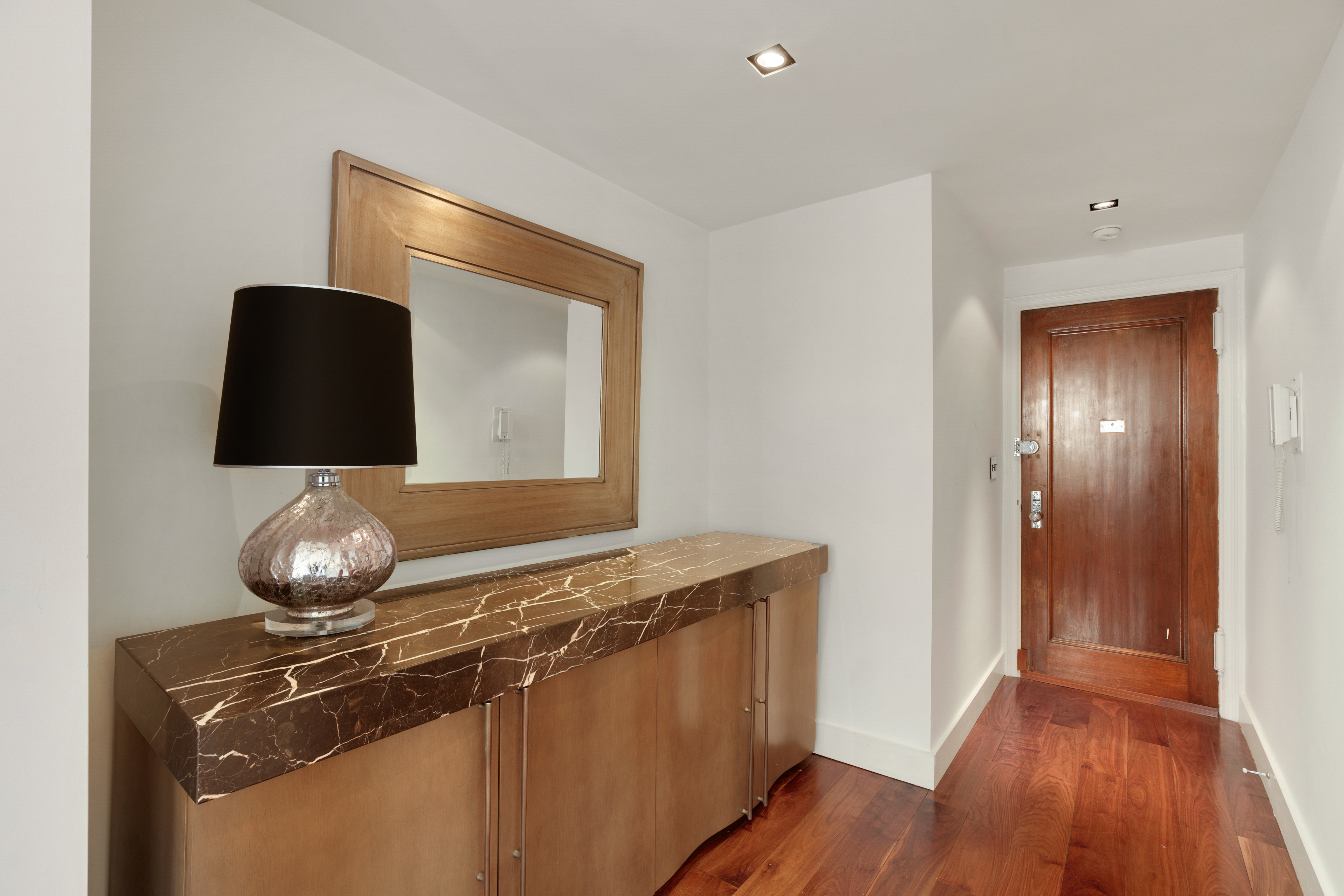 340 West 57th Street, Unit 8E Manhattan, NY 10019 - Photo 9 of 16 a living room with a sink and a mirror