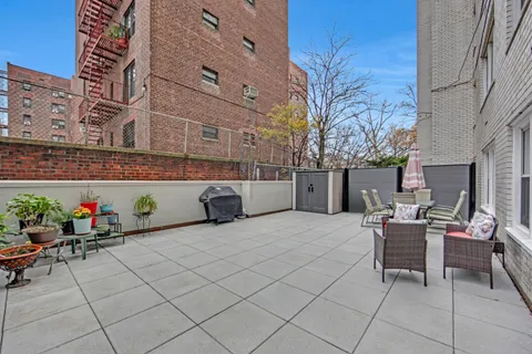 a view of a patio with dining table and chairs and potted plants