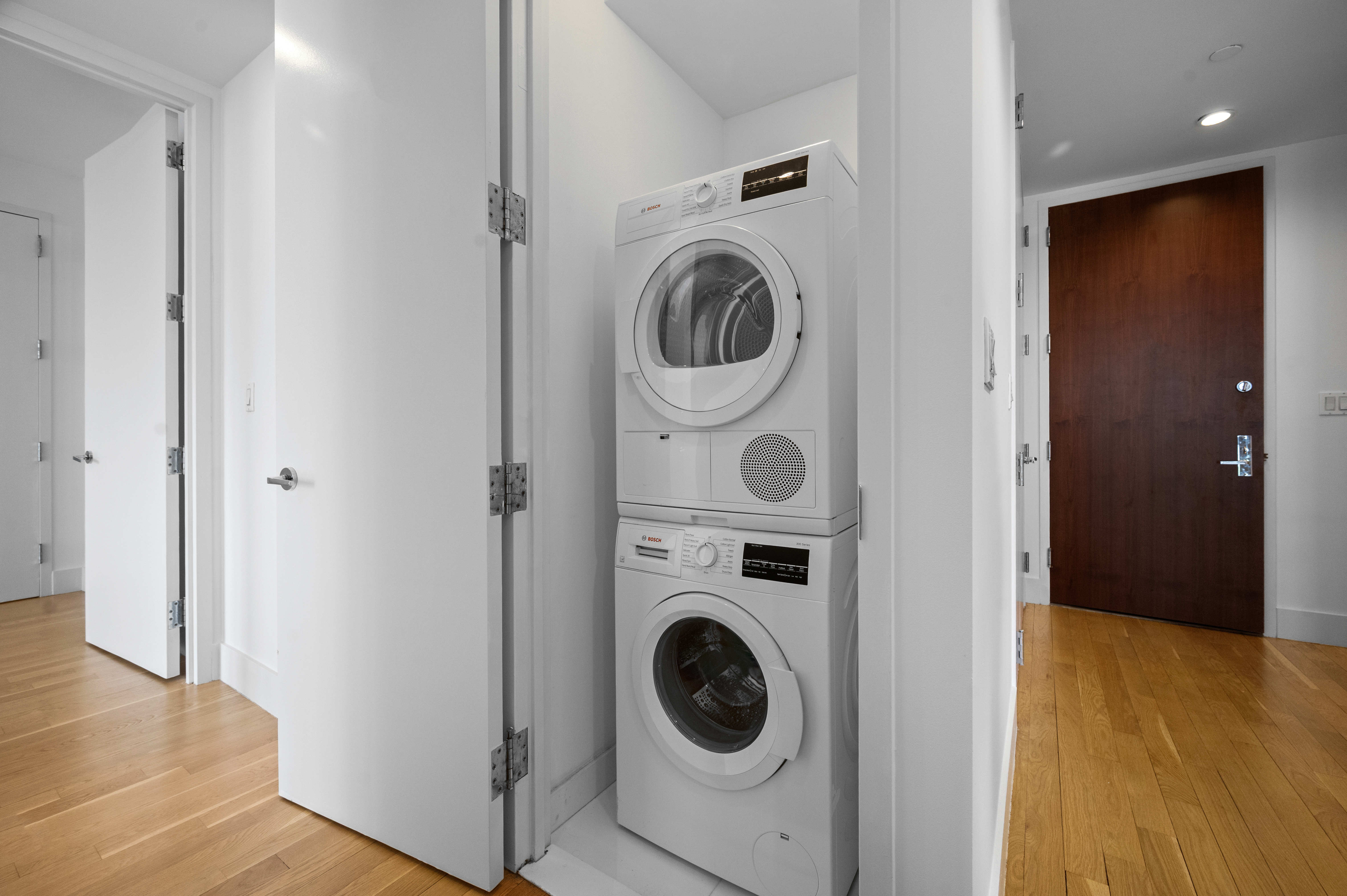 117 West 123rd Street, Unit 5D Manhattan, NY 10027 - Photo 13 of 18 a view of a hallway with washer and dryer