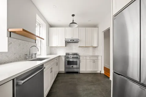 a kitchen with a sink stove and refrigerator