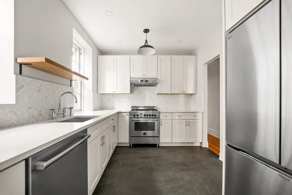 a kitchen with a sink stove and refrigerator