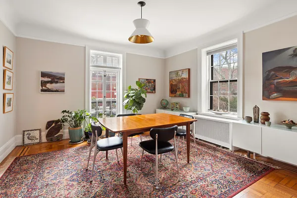 a dining room with a table and chairs