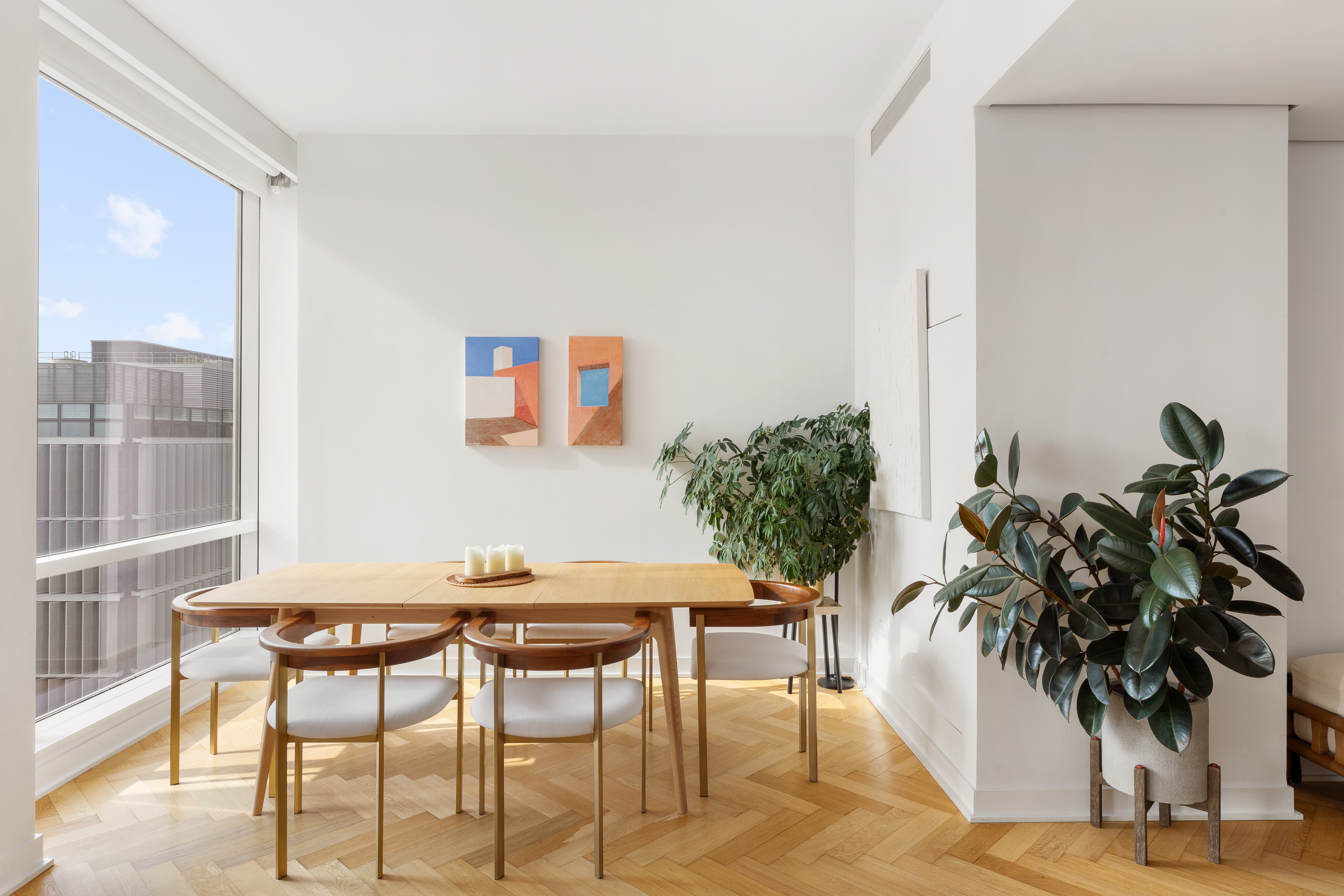 330 Spring Street, Unit 11B Manhattan, NY 10013 - Photo 4 of 10 a view of a dining room with furniture and a potted plant